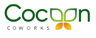 Cocoon Coworks logo in green typography with two orange leaf-shaped elements beneath the wordmark.