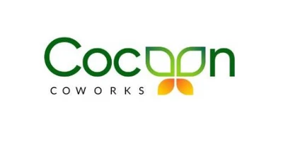 Cocoon Coworks logo in green typography with two orange leaf-shaped elements beneath the wordmark.