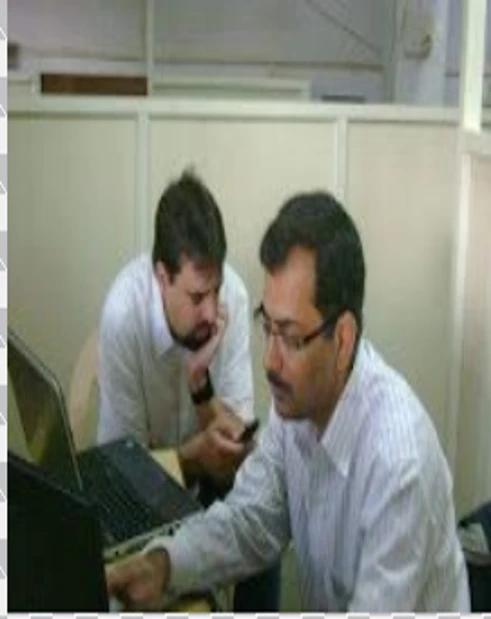 IT training session at Regent iTech showing instructor guiding a student on laptop during software development and programming training.